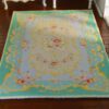 Victorian style miniature rug with turquoise and yellow floral motifs