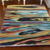 Modern abstract miniature rug with colorful flowing pattern