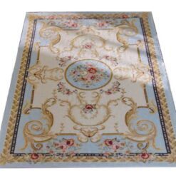 Victorian miniature rug with floral scrolls, roses, and a central medallion in soft pastel colors.