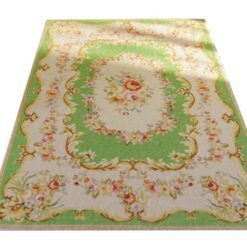 Miniature Aubusson rug with floral medallion and green background