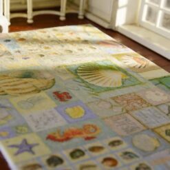 Miniature coastal rug with nautical motifs like lighthouses, starfish, and anchors.