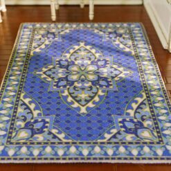 Persian miniature rug with a blue background, golden medallion, and intricate patterns.