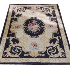 Black Victorian miniature rug with floral medallion and roses in pink and cream.