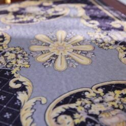 Purple miniature rug with yellow floral motifs and a central floral medallion design.