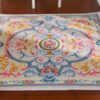 Floral French Aubusson miniature rug with vibrant pink, yellow, and blue flowers and a cream background.