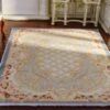 Miniature Aubusson-style rug in pastel blue with floral borders and intricate detailing.