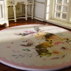 A miniature rug featuring a moose with floral designs and a bird on a white background.