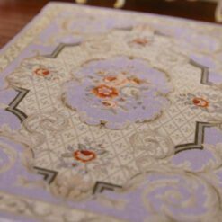 Victorian style miniature rug with purple background and floral accents