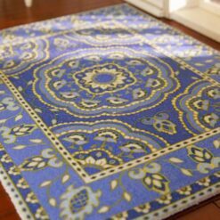 Persian miniature rug with a blue background, floral medallion, and intricate borders.