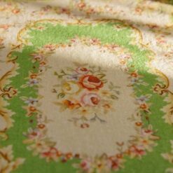 Miniature Aubusson rug with floral medallion and green background