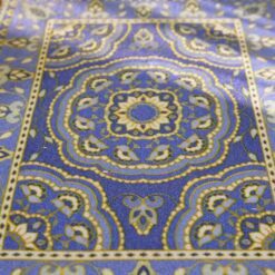 Persian miniature rug with a blue background, floral medallion, and intricate borders.