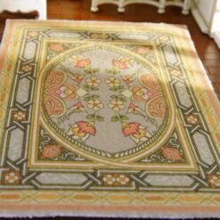 Modern abstract miniature rug with bold patterns in pink, black, blue, and green.