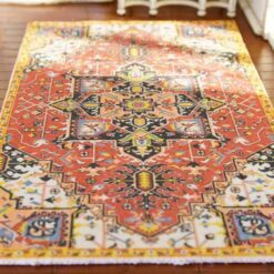 Miniature Persian rug with a red base, floral medallion, and intricate detailing.