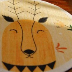 Miniature rug with an abstract deer head and playful motifs like a bee and flower.
