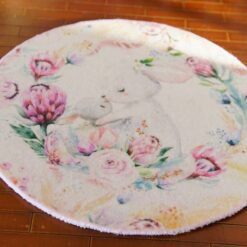 A round rug with a rabbit mother and baby surrounded by delicate flowers