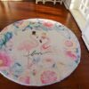 A round rug with two flamingos surrounded by pastel flowers and a "Love" inscription.