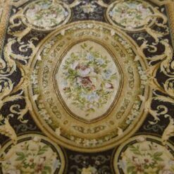 French Aubusson Floral Miniature Rug 11 French Aubusson miniature rug with floral medallions and gold scroll designs on a dark brown background.