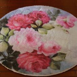 Miniature rug with pink roses and green leaves in a soft, pastel color scheme.