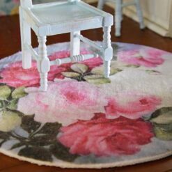 Miniature rug with pink roses and green leaves in a soft, pastel color scheme.