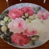 Miniature Floral Rose Rug 1 Miniature rug with pink roses and green leaves in a soft, pastel color scheme.
