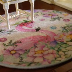 Miniature rug with a pink flamingo and pastel-colored flowers, including pink, purple, and blue hues.