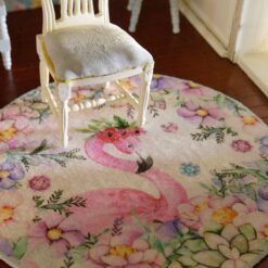 Miniature rug with a pink flamingo and pastel-colored flowers, including pink, purple, and blue hues.
