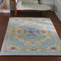Victorian style miniature rug in light blue and yellow with floral accents