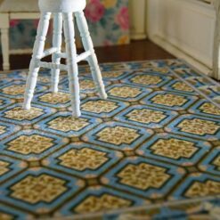 Geometric pattern miniature dollhouse rug with gold medallions on blue background