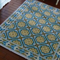 Diamond pattern miniature dollhouse rug with gold medallions and blue background