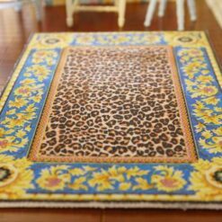 Miniature dollhouse rug with leopard print center and golden sunflower border