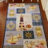 Miniature dollhouse rug with nautical symbols and lighthouse design