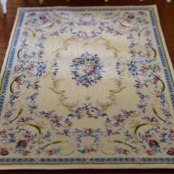 Miniature dollhouse rug with blue and pink floral Aubusson design
