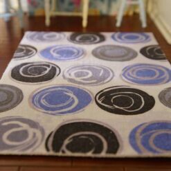 Modern miniature dollhouse rug with blue and gray circular pattern