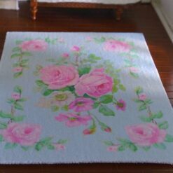 Light blue miniature rug with pink roses and green vine