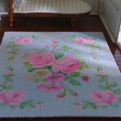 Light blue miniature rug with pink roses and green vine