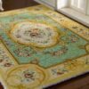French Aubusson floral rug with green background and gold trim