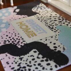 Modern abstract rug with pastel colors and "SWEET HOME" text