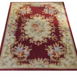 Victorian-style miniature rug in burgundy, with floral medallion and intricate scroll patterns.