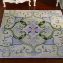 Pastel green miniature rug with swirls, vines, and floral accents, perfect for modern dollhouse interiors.
