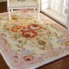 Pink miniature rug with floral scrolls and roses, perfect for adding a romantic touch to any dollhouse.