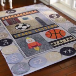 Miniature rug with an educational theme featuring letters, numbers, and playful images like a rocket and basketball.