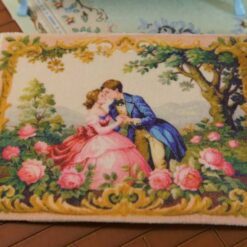 Romantic couple in a floral garden with golden accents, a miniature Aubusson tapestry.