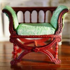 Victorian miniature bench with green cushion and curved design