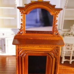 Victorian-style miniature fireplace with mahogany finish and mirror