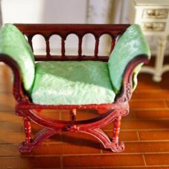 Victorian miniature bench with green cushion and curved design