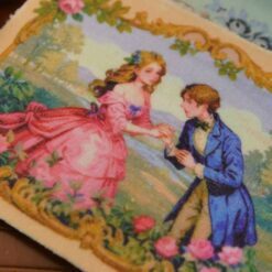 A romantic proposal scene with a couple in vintage attire, surrounded by roses and framed with gold, a miniature Aubusson tapestry.