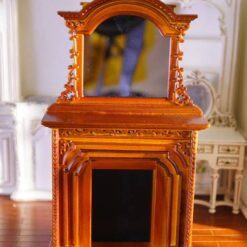 Victorian-style miniature fireplace with mahogany finish and mirror