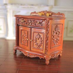 Baroque-style miniature vanity sink with gold faucet