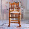 Victorian-style miniature wooden high chair with fabric seat
