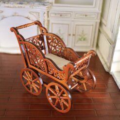 Miniature Victorian wooden baby carriage with cushion